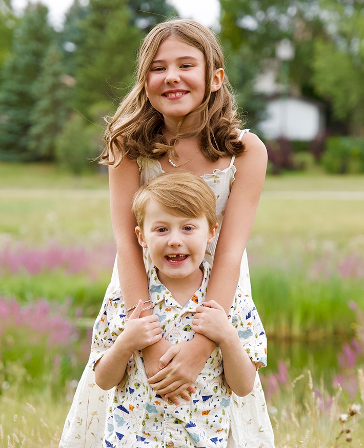 Two children smiling at the camera