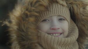 close up of a young girl in winter gear, smiling