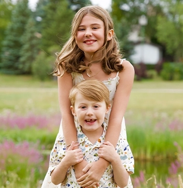 Two children smiling at the camera