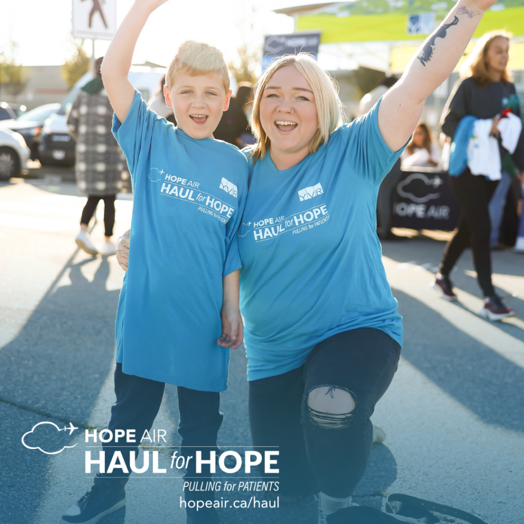 an adult and child smiling and wearing hope air branded t-shirts on a sunny day